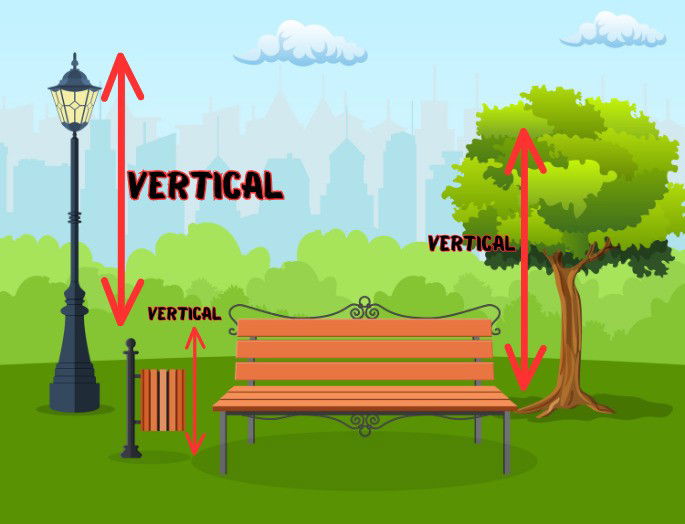 parque con una farola, una papelera y un árbol que son ejemplos de verticalidad